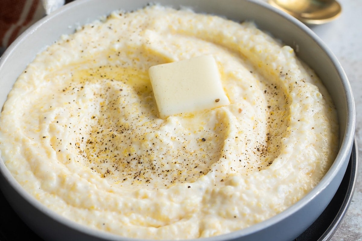 Uma tigela de sêmola com um bocado de manteiga no meio.